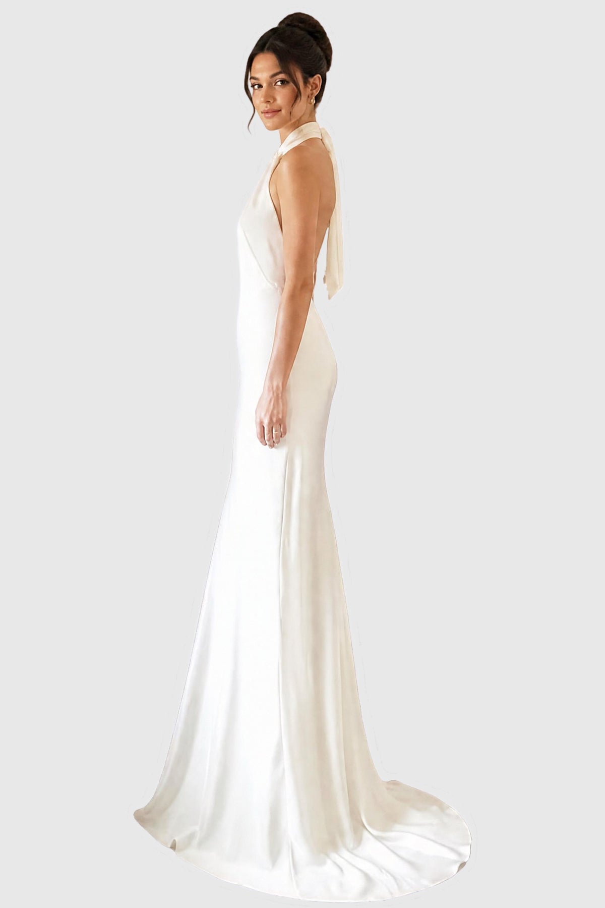 A bride wearing a long bias cut halter neck wedding dress in silk.