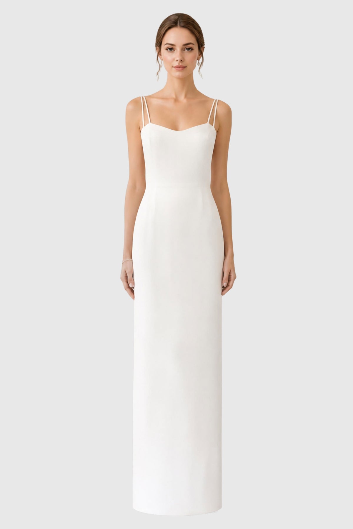 A model wearing a floor-length light ivory spaghetti-strap dress in silk crepe