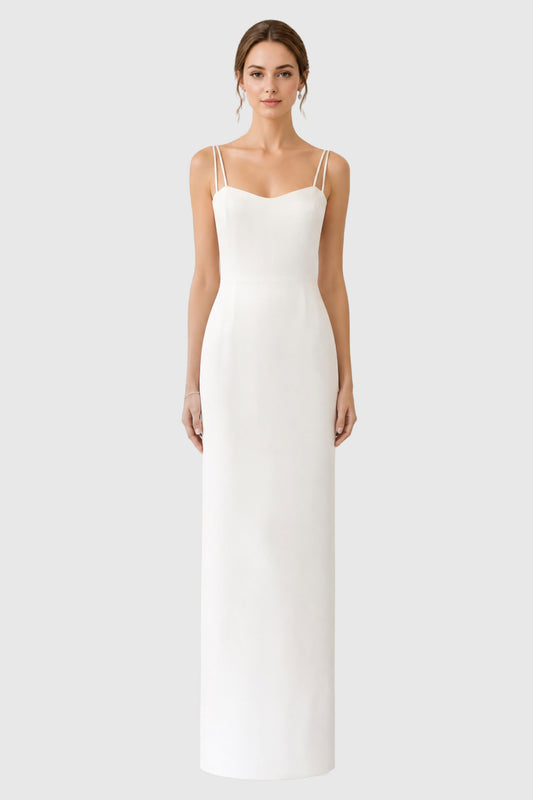 A model wearing a floor-length light ivory spaghetti-strap dress in silk crepe